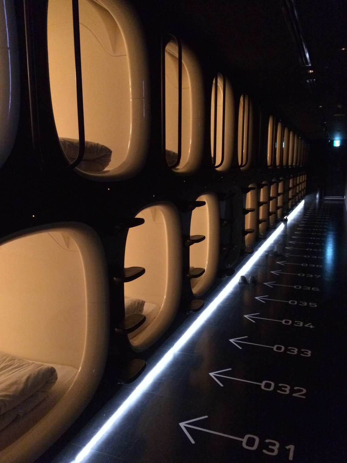 Row of sleeping pods inside the 9h nine hours capsule hotel at Narita Airport